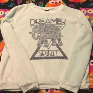 a turquoise sweatshirt with a design.